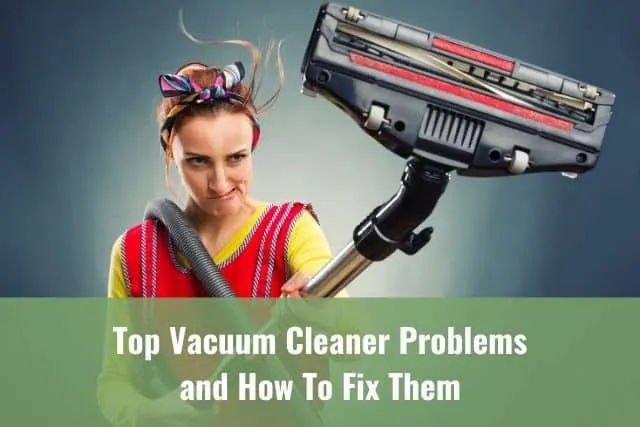 Woman holding a stick vacuum up high