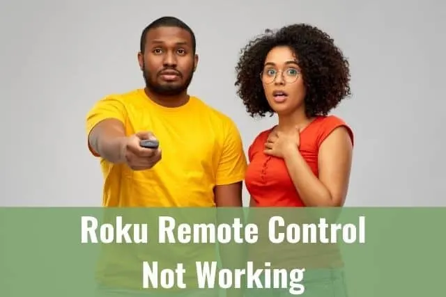 Black couple standing next to each other with man holding TV remote