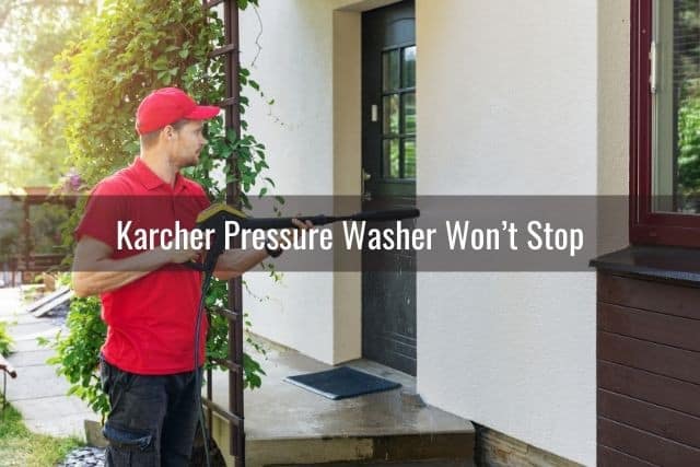 Guy pressure washing house wall