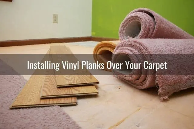 Floor planks and rolls of carpet on floor