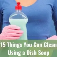 Woman in rubber gloves holding a bottle of dish soap