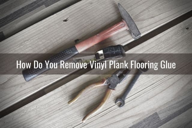 Wood flooring tools laying on vinyl planks