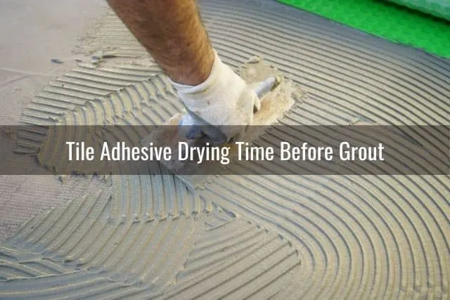 Hand with trowel applying floor adhesive
