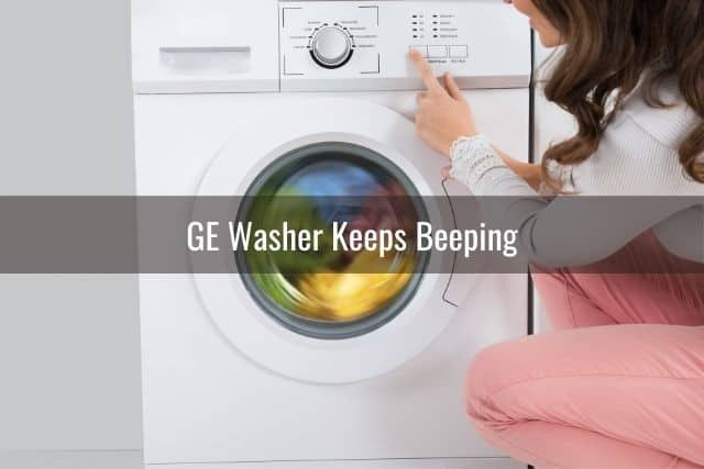 Woman pressing buttons on a washing machine 