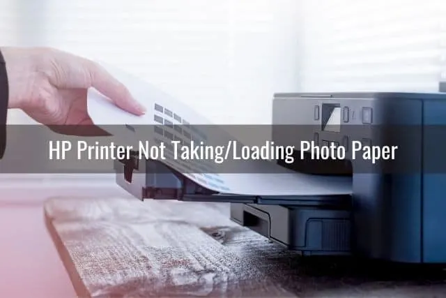 Hand removing paper from printer