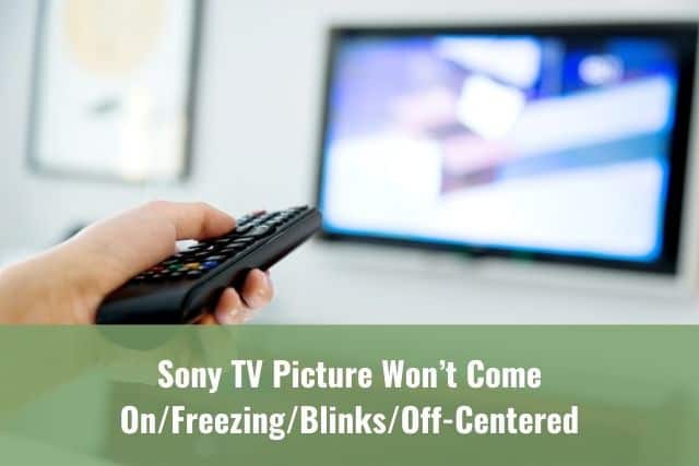 Hand changing TV channels with remote