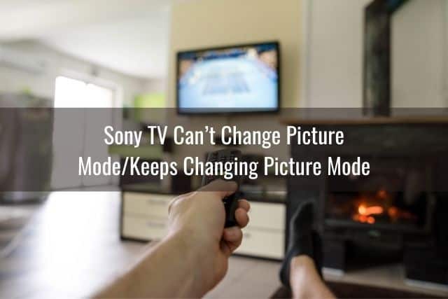 Hand changing TV channels with a remote