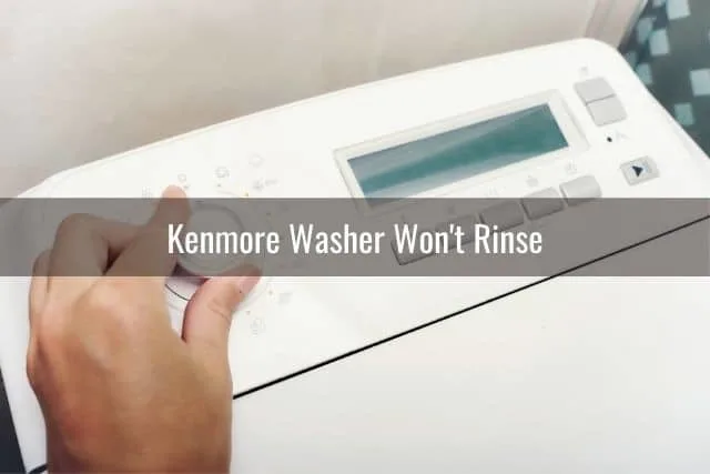 Hand adjusting washing machine knob settings