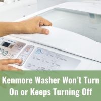 Finger pushing buttons on white washing machine