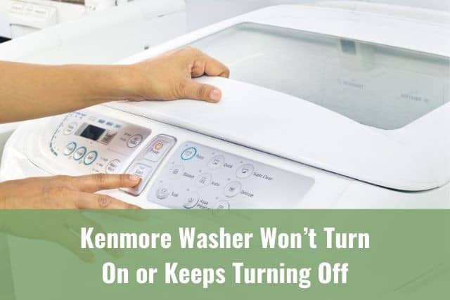 Finger pushing buttons on white washing machine