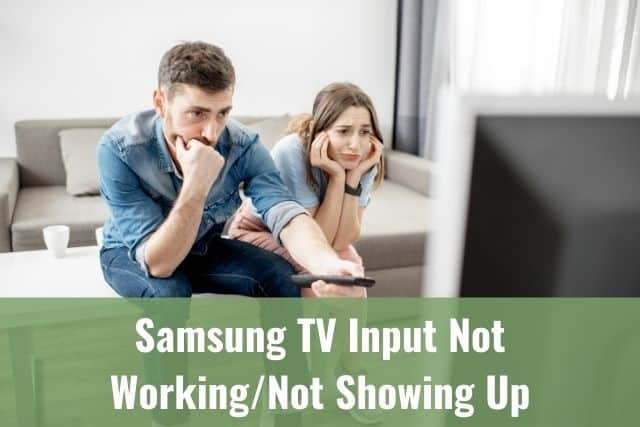 A couple looking annoyed while watching TV