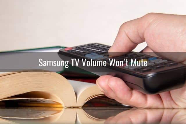 Hand adjusting volume on TV remote