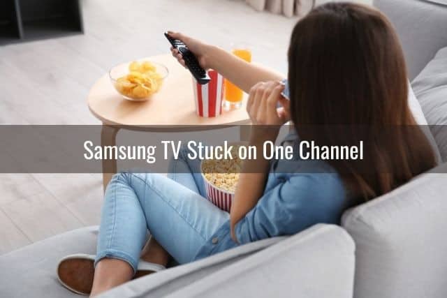 A girl with a TV remote changing channels while eating popcorn