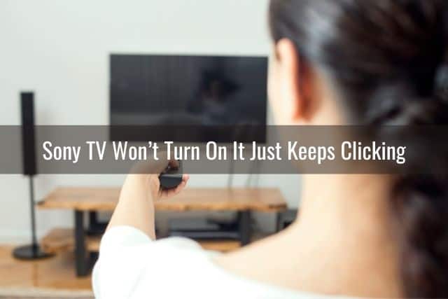 Female holding remote to turn TV on