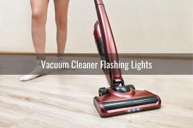 Red upright vacuum on vinyl floor