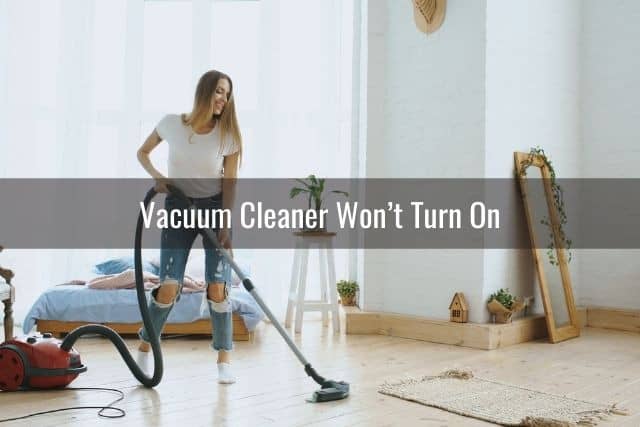 Woman vacuuming hardwood floors