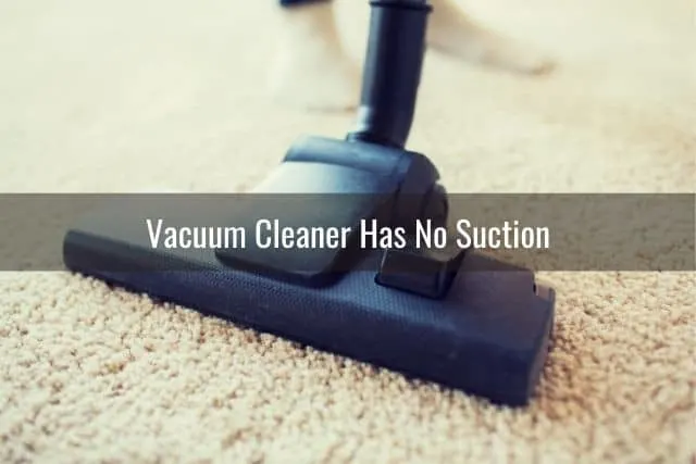 Close up view of stick vacuum brush roller on white carpet