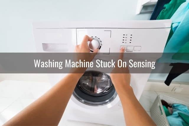 Hand adjusting the washing machine knob