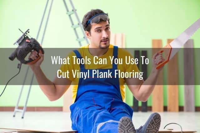 A handyman sitting on the floor with different kinds of saw in each hand