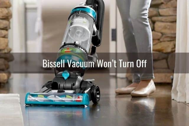 Upright vacuum on dark hardwood floor