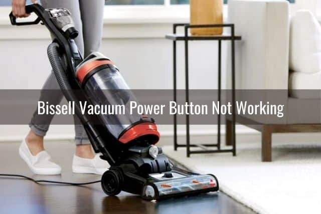 Upright corded vacuum on dark hardwood floor