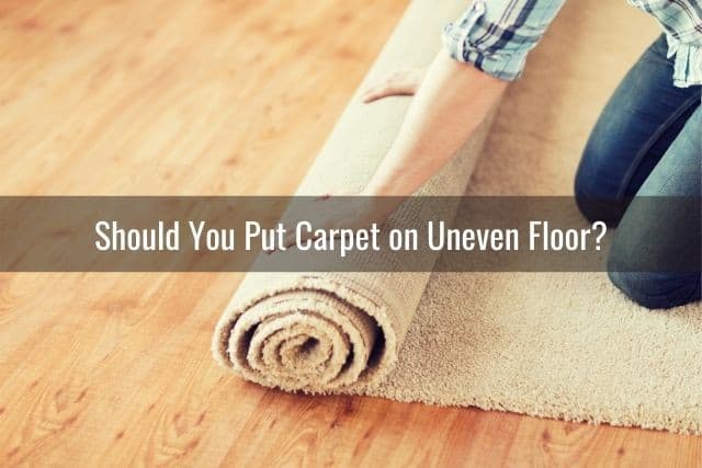 Hand rolling out carpet flooring installation
