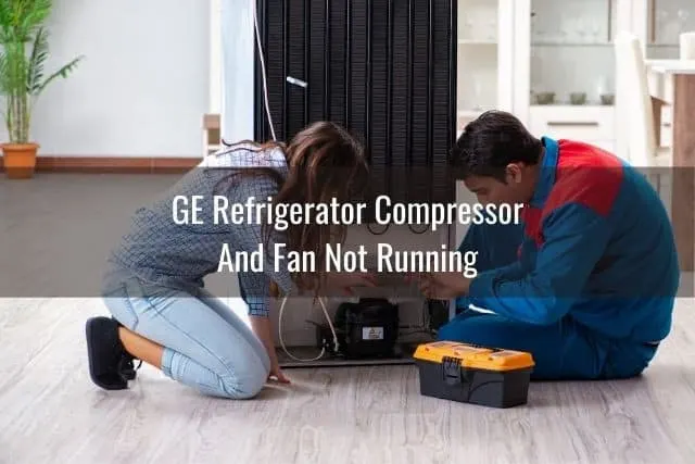 Repairman and lady kneeling on ground looking at refrigerator problem