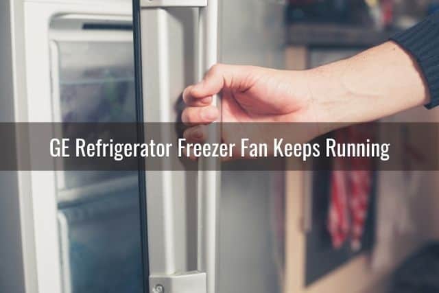 Hand pulling on refrigerator door handle