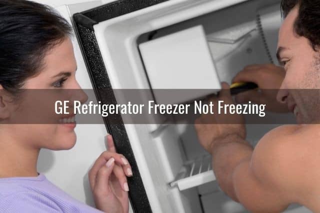 Repairman fixing refrigerator freezer