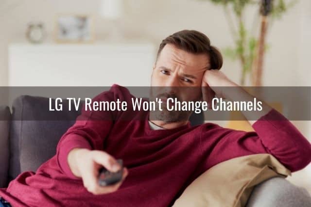 Annoyed man changing TV channels with remote