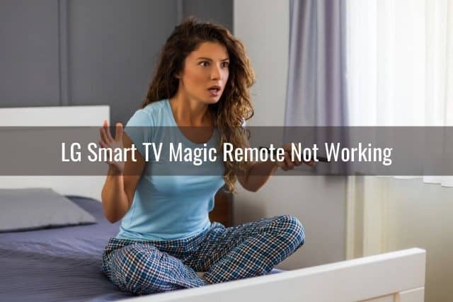 Female sitting on bed confused her TV remote is not working
