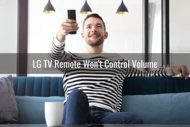 Male holding a TV remote and pointing it up