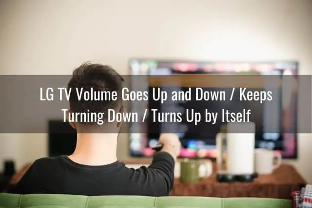 Male sitting on sofa pointing remote at TV