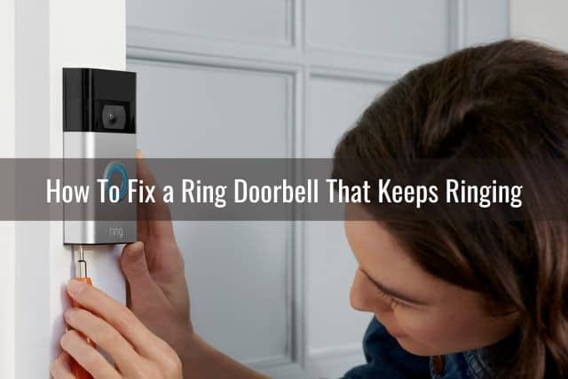 Person installing a video camera doorbell by front door