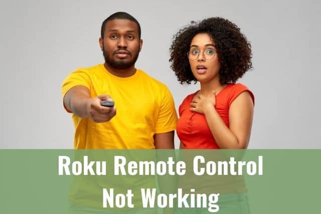 Black couple standing next to each other with man holding TV remote