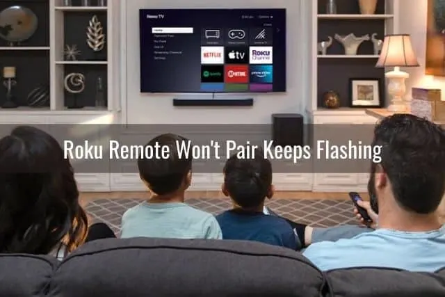Family sitting on sofa in front of Smart TV