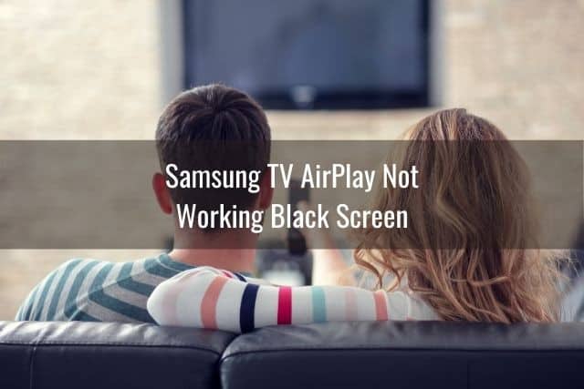 Couple sitting on sofa starring at black TV screen