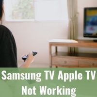 Female sitting on sofa changing TV channels with remote