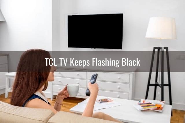 Woman turning TV on with remote