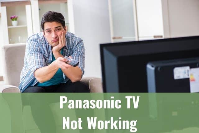 Baffled male sitting on sofa wondering why TV is not working