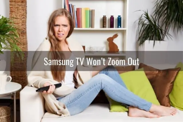 Annoyed female holding TV remote