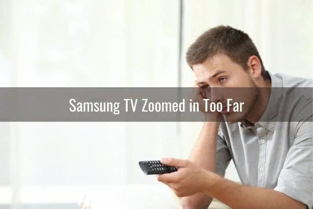 Bored male holding remote while watching TV