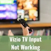 Person using remote to change TV channel programs