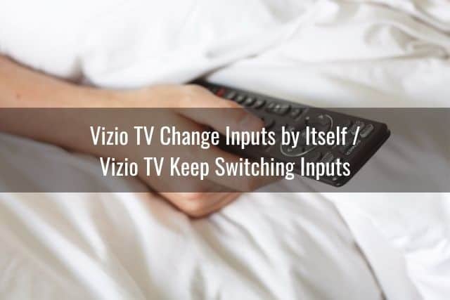 Hand using TV remote to change channels