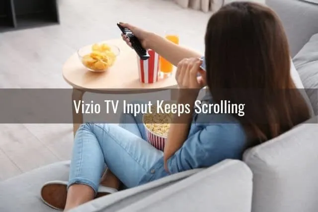 Female watching a movie on TV and eating popcorn