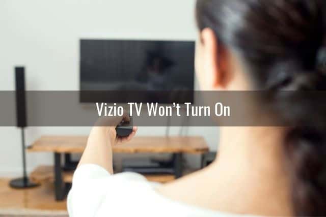 Female using remote to turn TV on