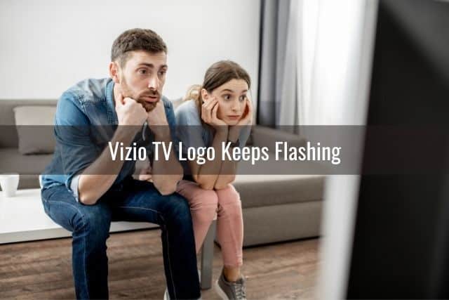 White male and female sitting in front of TV