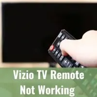 Hand holding TV remote turning TV off