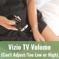 Female holding TV remote in her lap