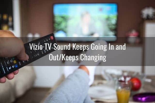 Person holding TV remote and changing channels